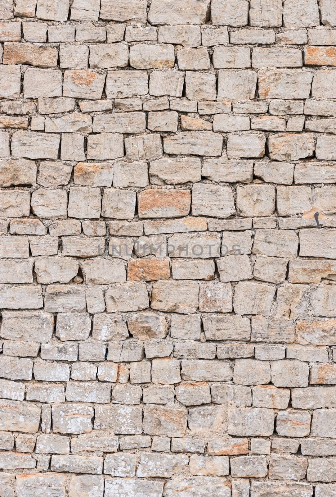 Old grey stone wall background texture, close-up