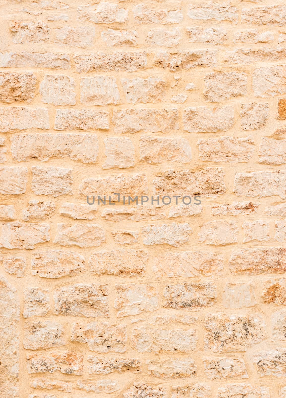 Vintage light brown stone wall background texture 

