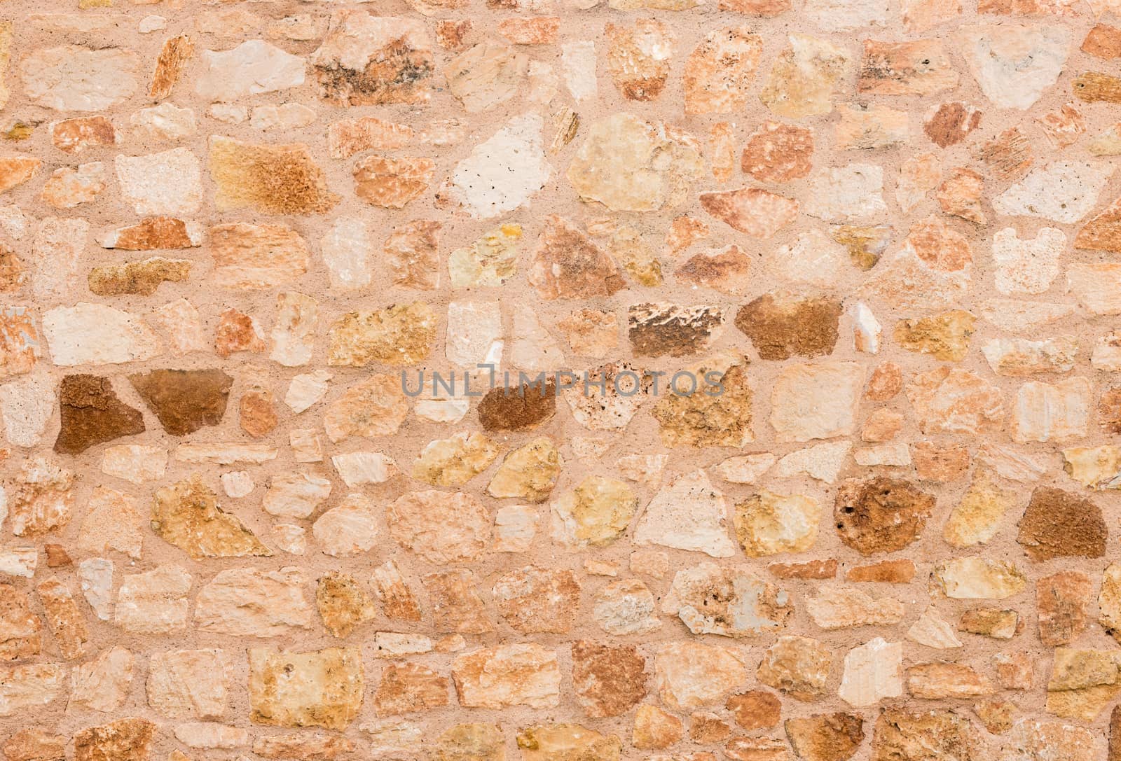 Rustic old brown stone wall background texture