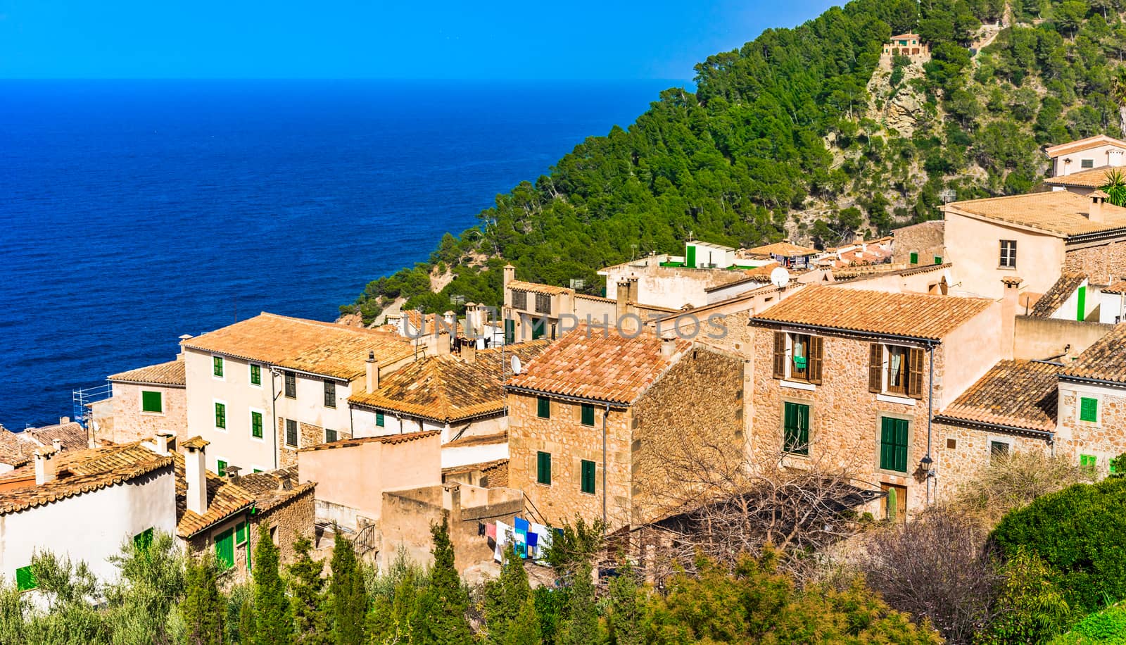 Coastline on Mallorca island with view of the mediterranean old village of Banyalbufar, Spain