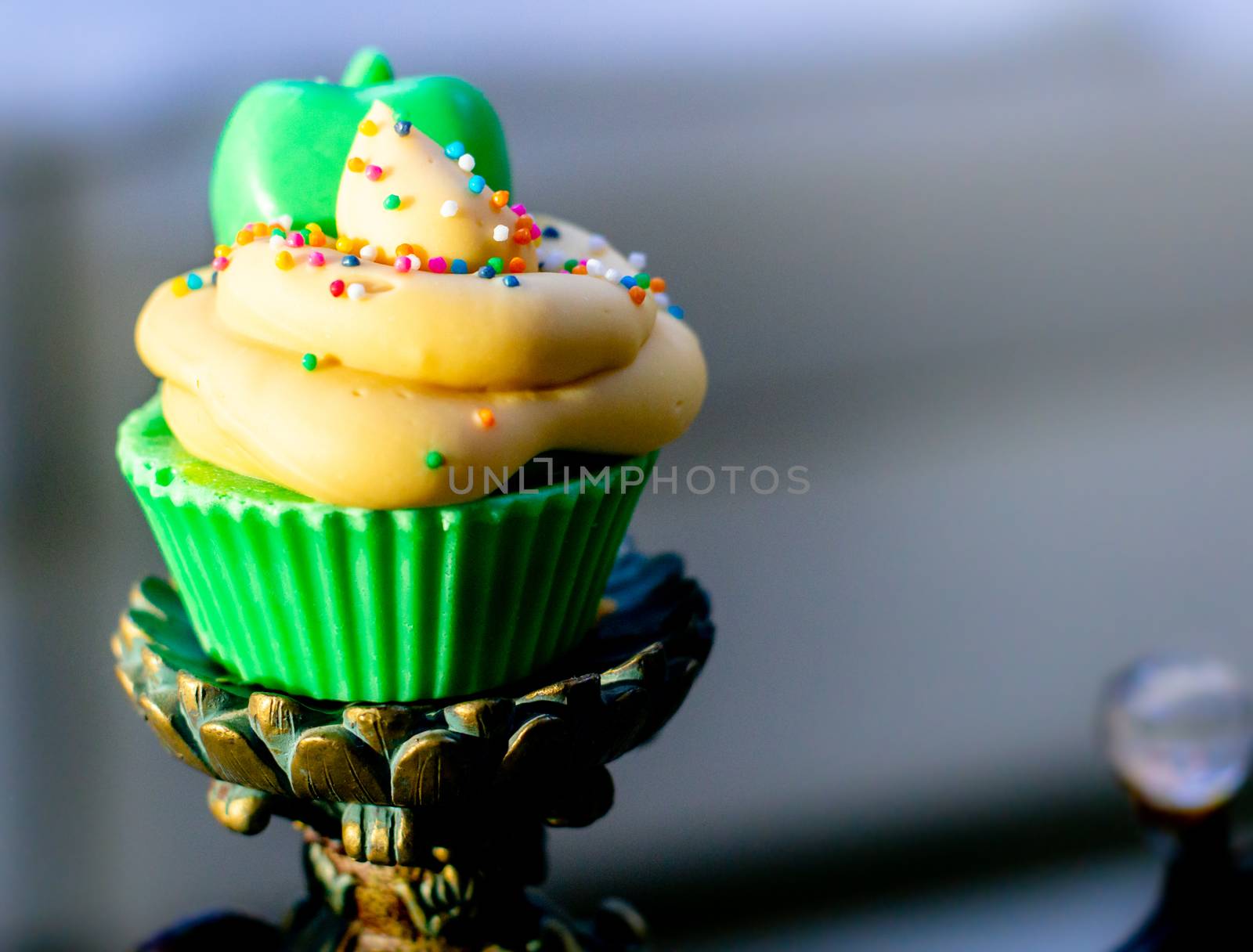 beautiful cupcakes soap with purple and green icing on pink and dark chocolate base with candy sprinkles placed on a wooden backdrop by Shalinimathur