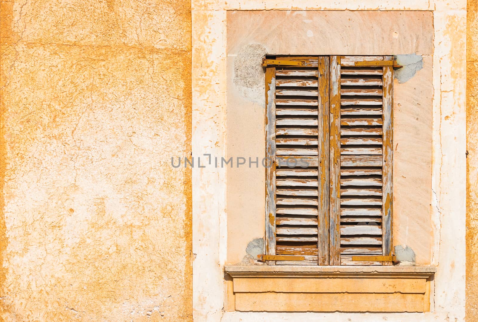Detail view of old wooden window shutters and wall background