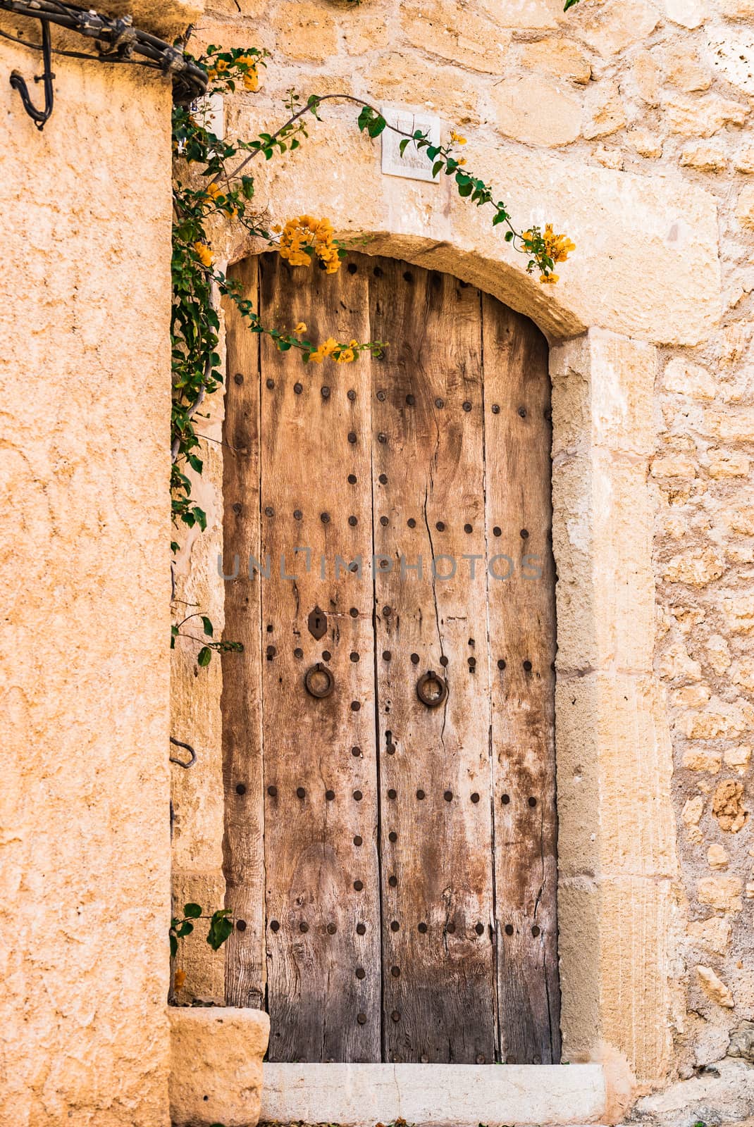 Old wooden front door with stone wall  