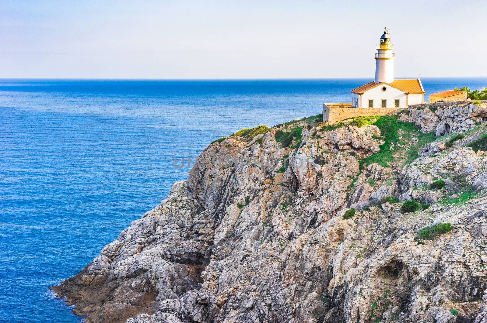 Beautiful view of the lighthouse at cliffs on the coast of Mallorca island, Spain Mediterranean sea