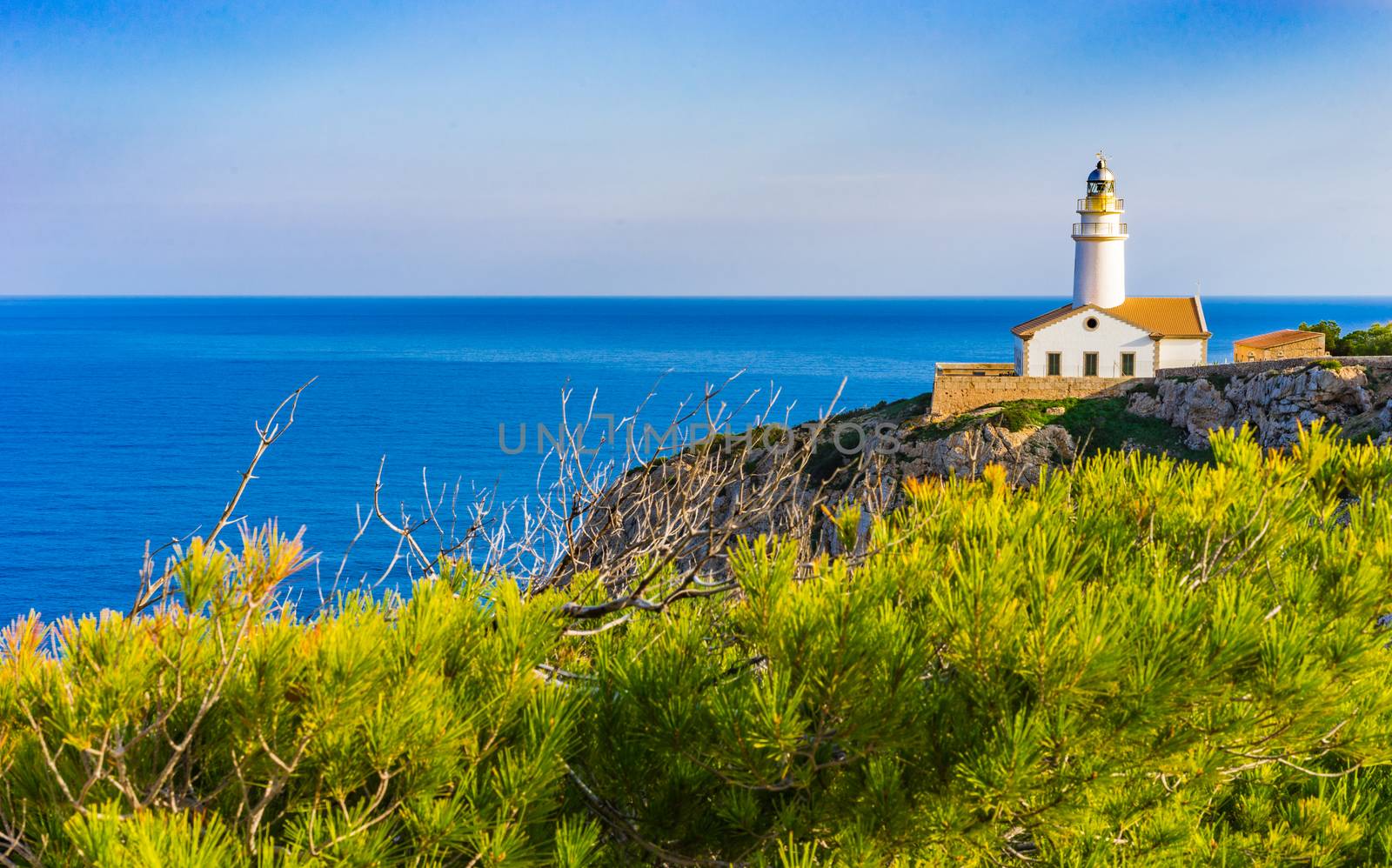 Maritime view with light house at the cape in Cala Rajada on Mallorca, Spain Mediterranean Sea