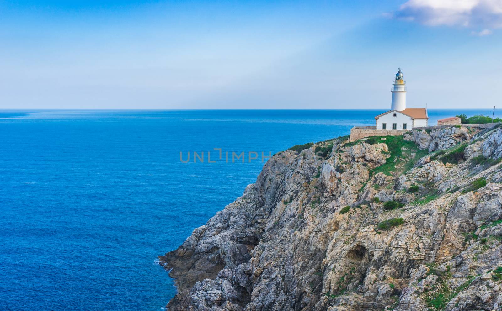 Light house at the cliffs of cape in Cala Ratjada on Mallorca, Spain Balearic islands