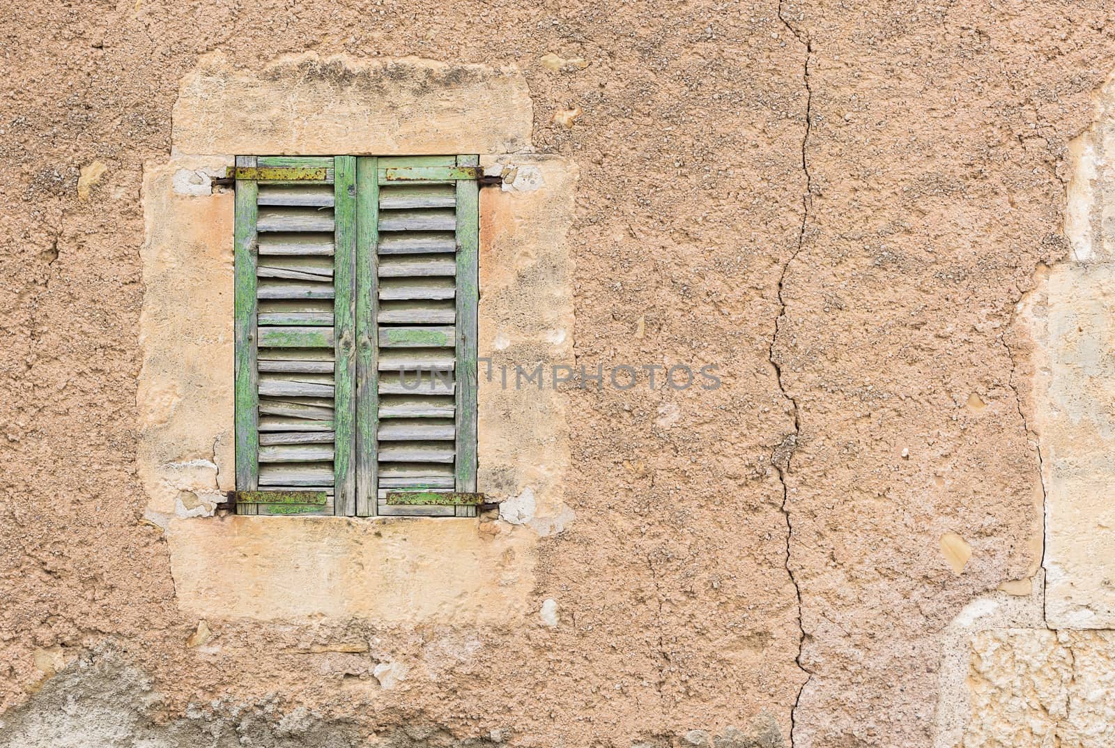 Detail view of vintage wooden window shutters and grunge wall background