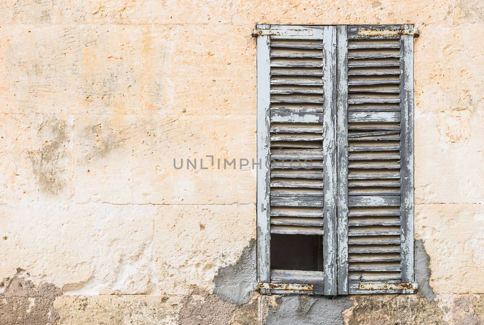 Detail view of old damaged window shutters and vintage wall