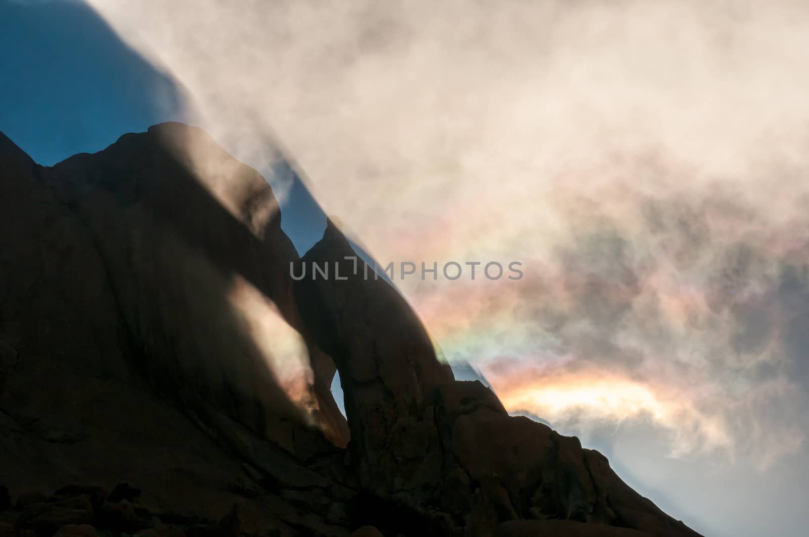 Reflections and diffraction are visible in the clouds at the Greater Spitzkoppe during sunrise