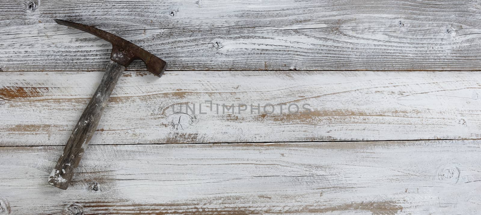 Vintage construction hammer on white rustic wooden boards by tab1962