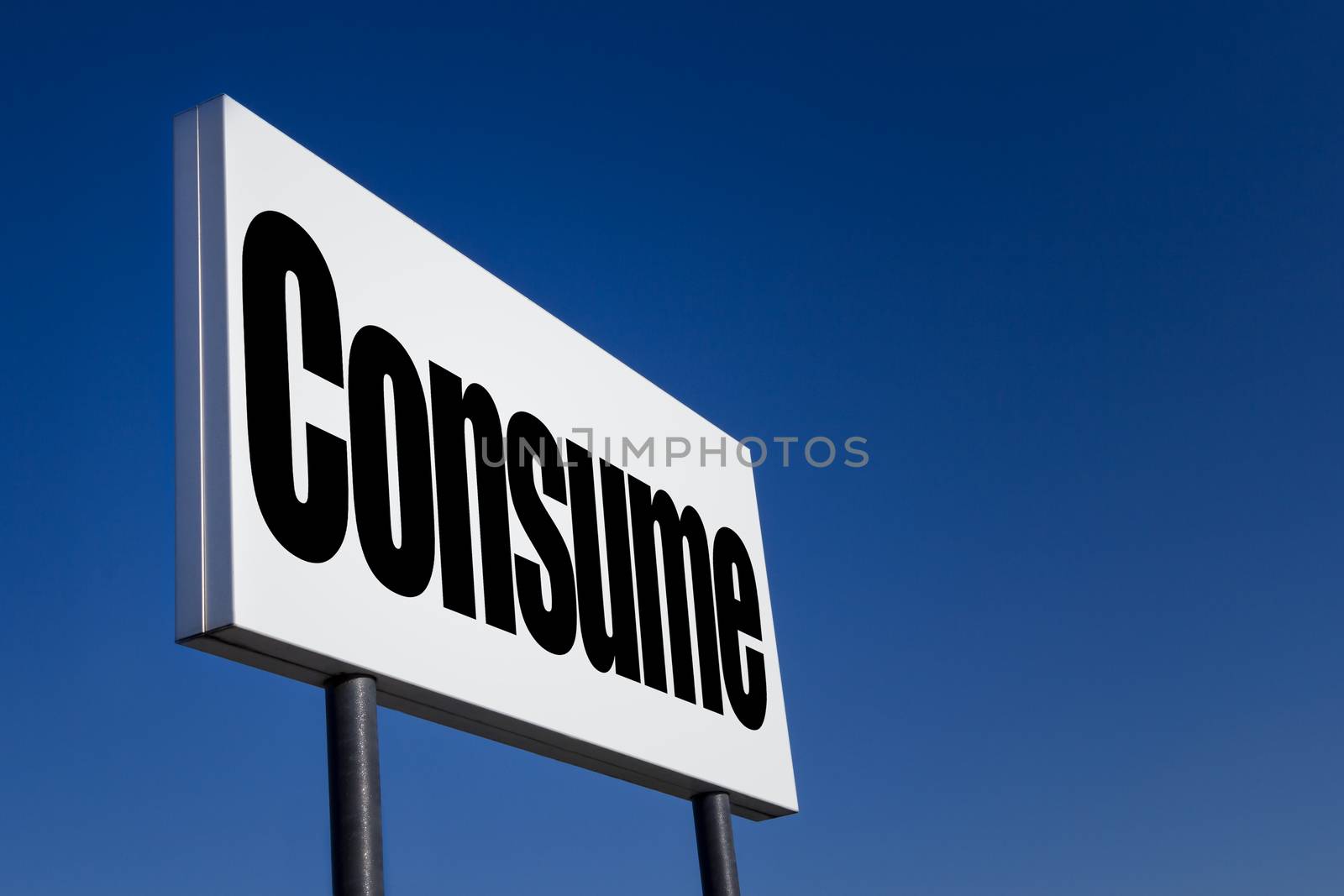 Big ad panel, embossed with the message "Consume", isolated on blue sky.