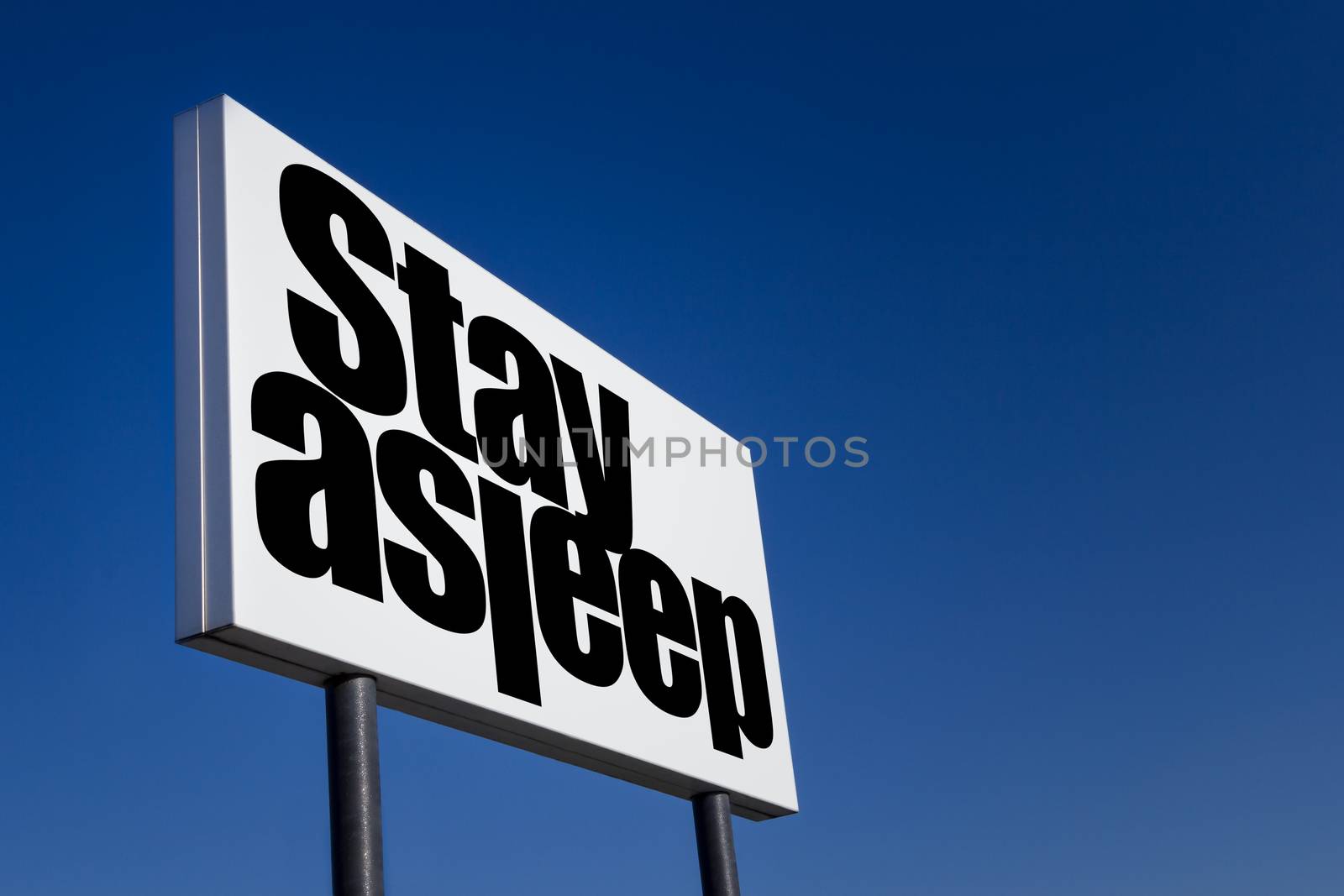 Big ad panel, embossed with the message "Stay asleep", isolated on blue sky.