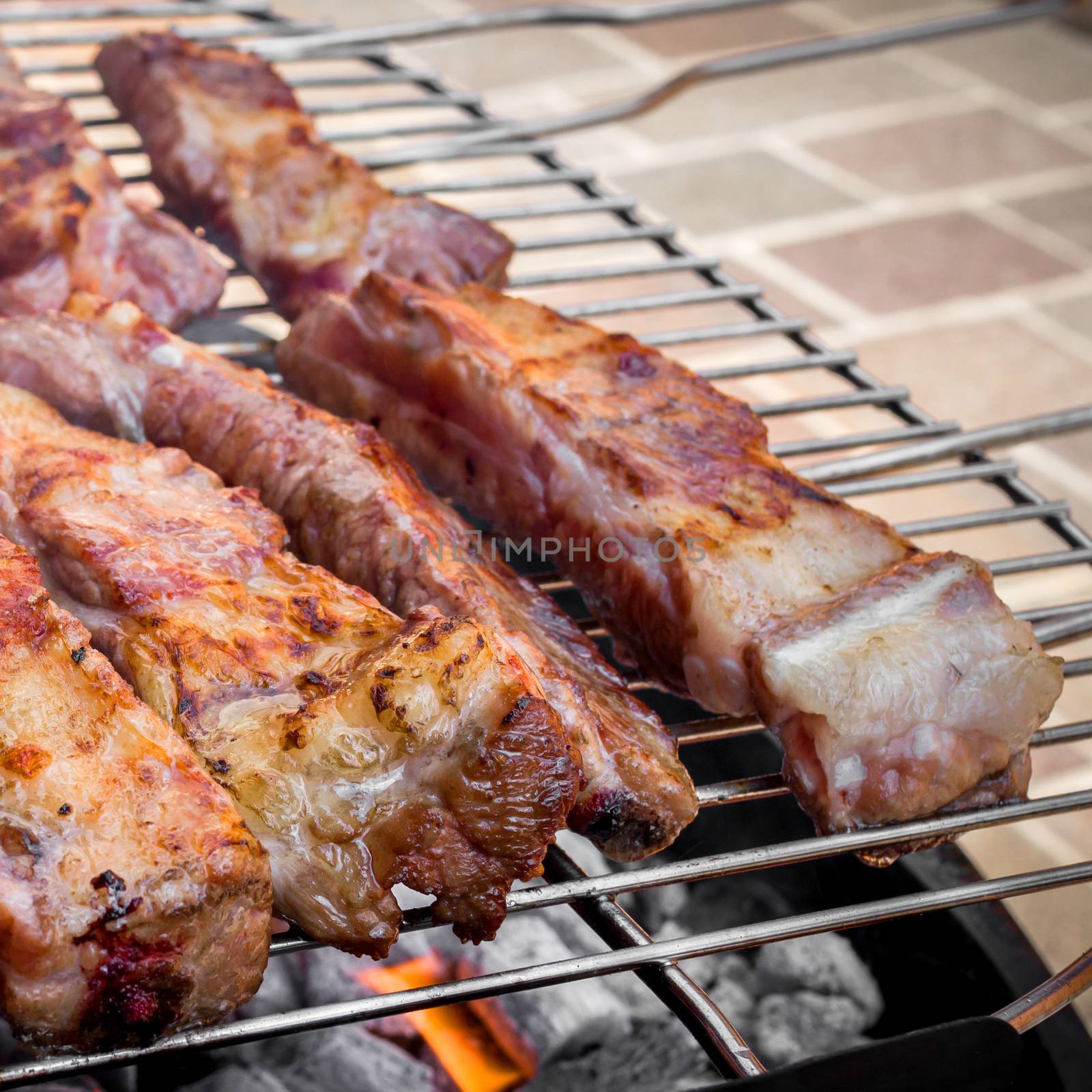 Grilled pork ribs on bbq grill.