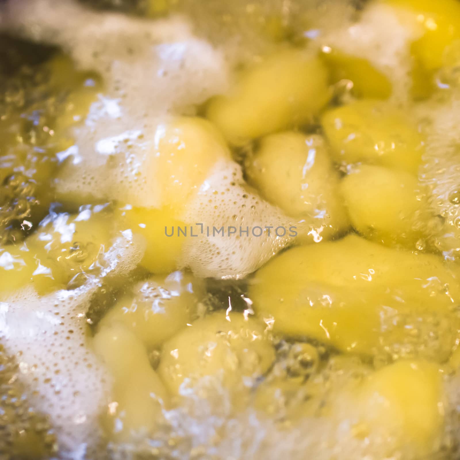 Potatoes simmering in boiling water by germanopoli