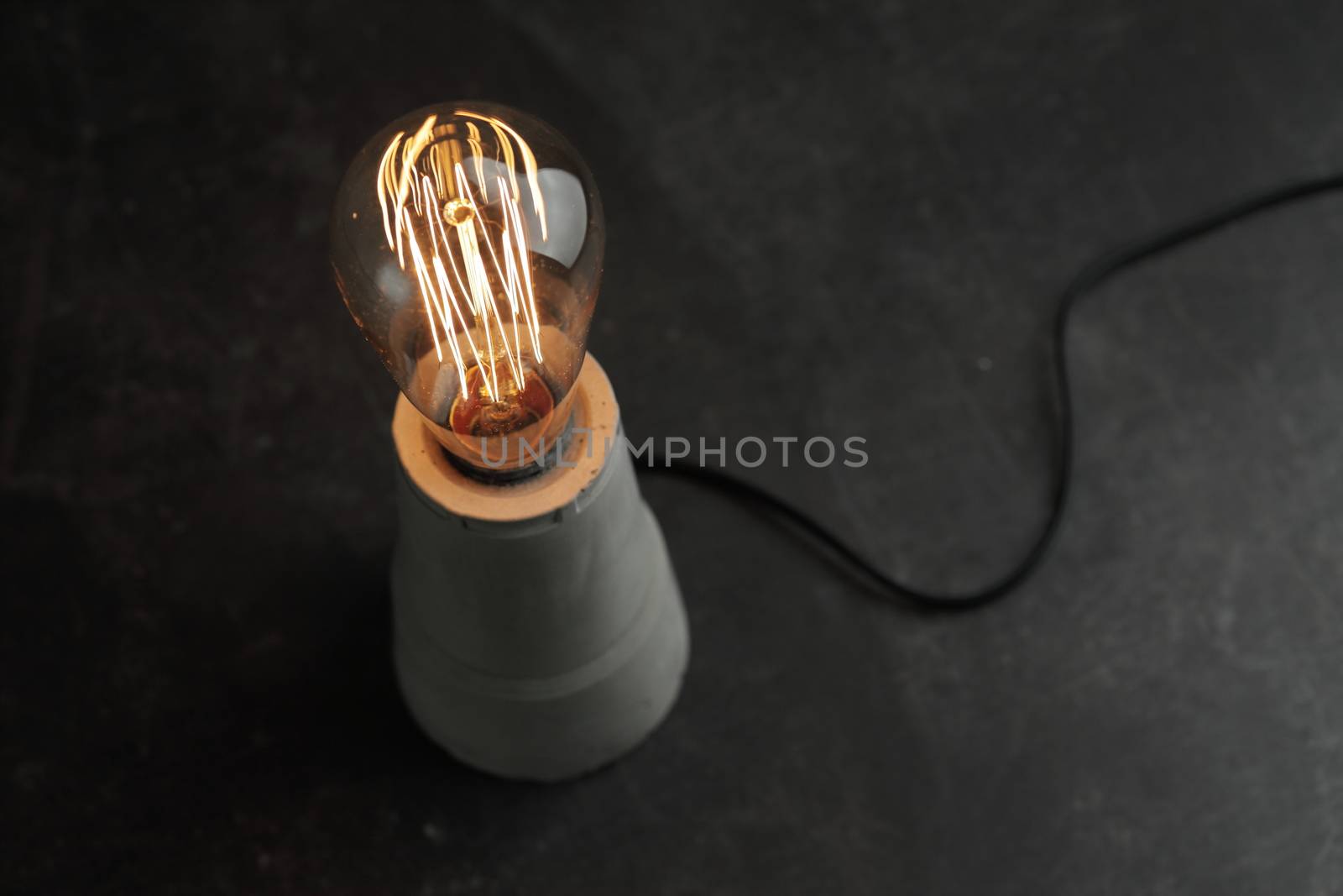 Retro lamp with Edison lamp on concrete. The concept is a good idea. High quality photo