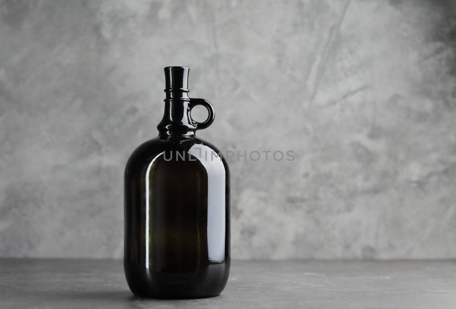Wine bottle on a concrete background. Free space for inscription. by selinsmo