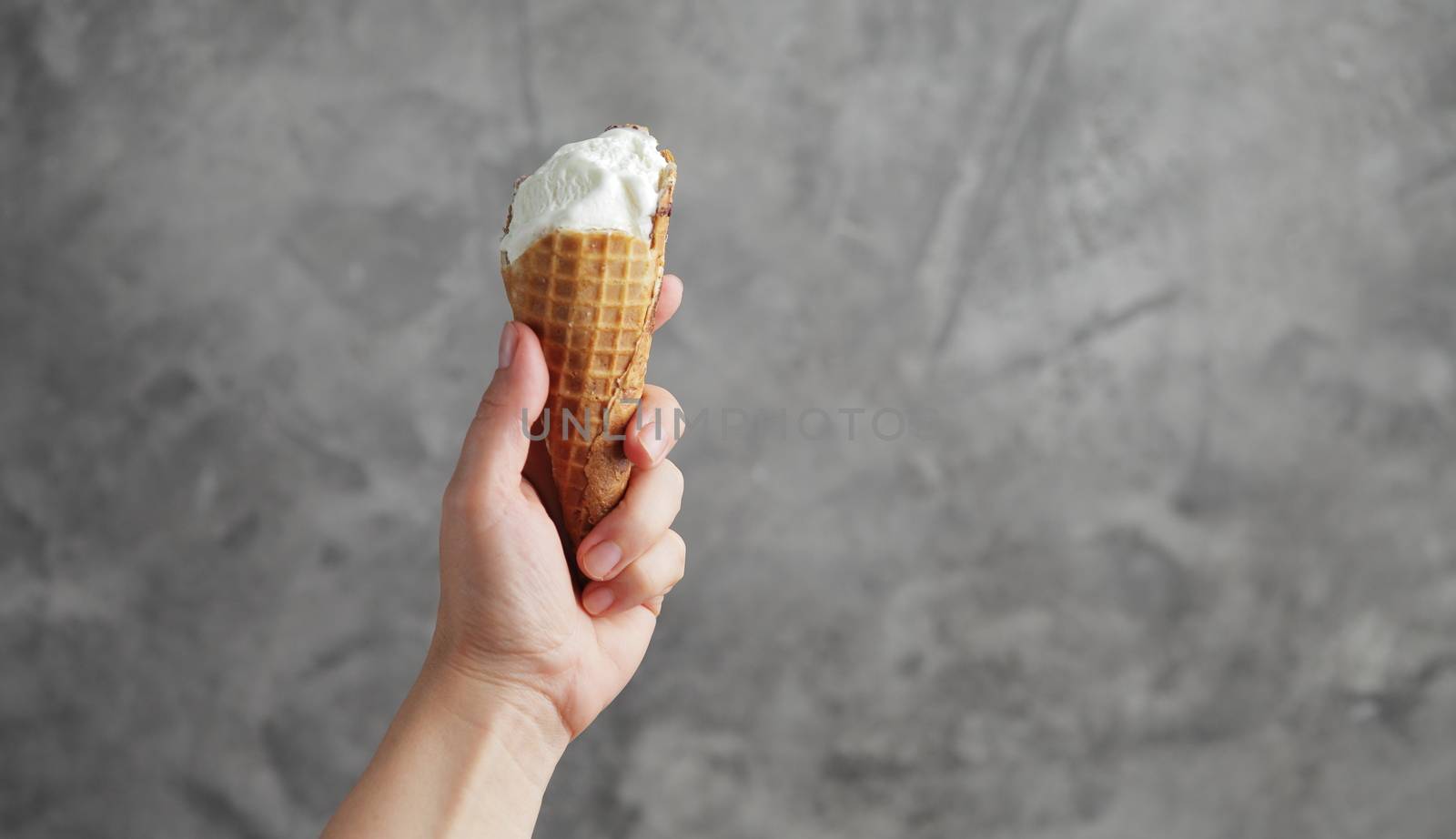 Ice cream in a female hand. Sweet dessert. High quality photo