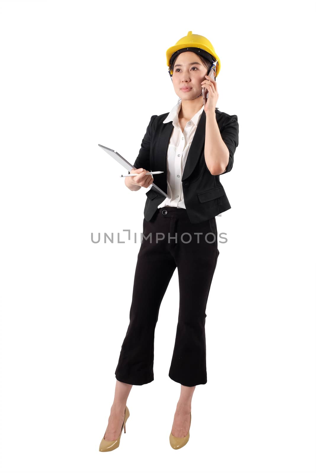 Young woman engineer holding digital tablet and using mobile phone isolated on white background