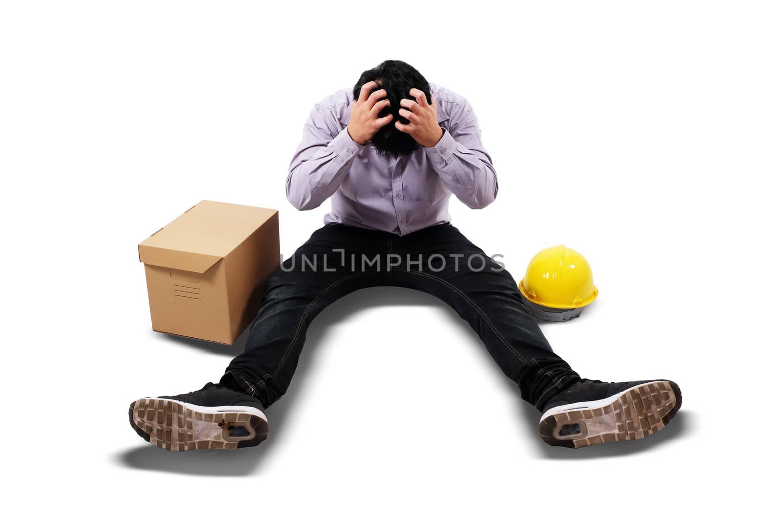 a man just lost his job sitting on the floor with his head down  by Surasak