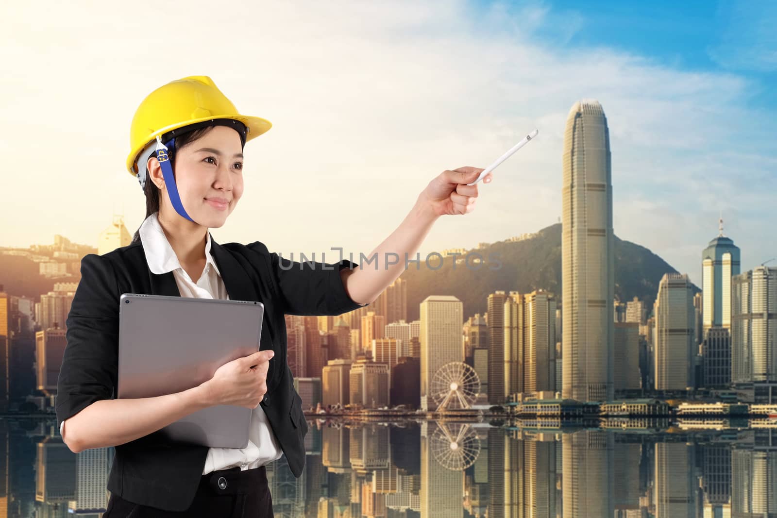 Young woman engineer holding digital tablet wtih smile in daylig by Surasak