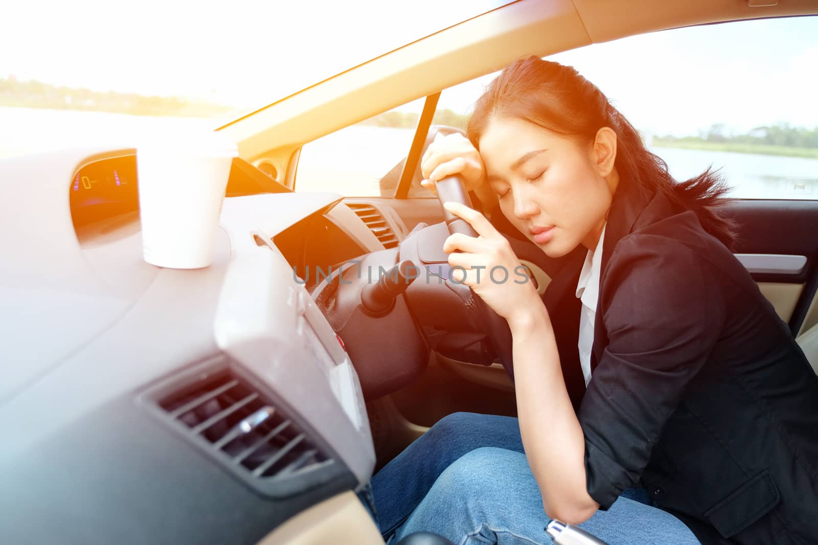 Tired young woman fall asleep in her car