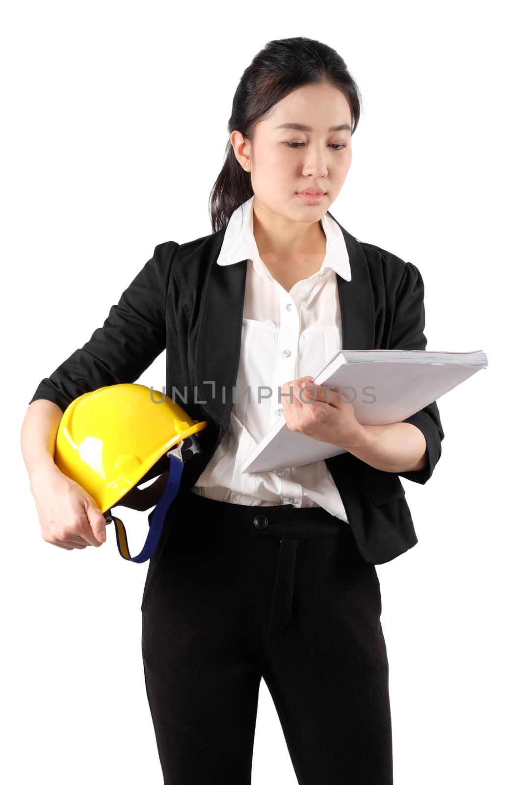 Young woman engineer holding a yellow helmet and reading constru by Surasak