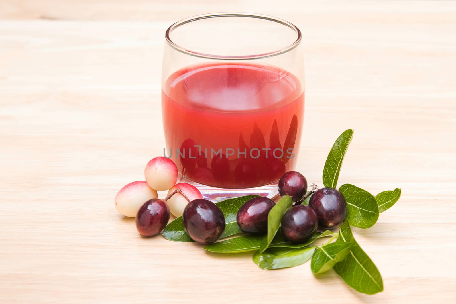 fresh Carissa carandas glass of juice with Carissa carandas fruits and Healthy drinks concept

