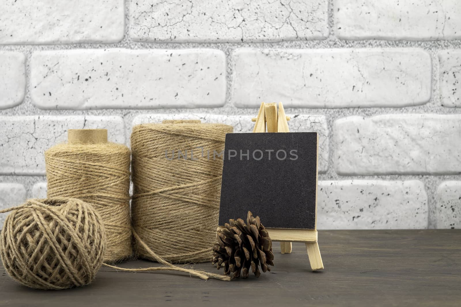 Assorted balls of hemp twine and slate chalkboard in a close up rustic still life