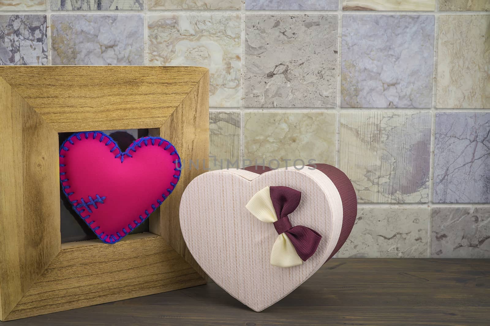 Heart in a wooden frame with a gift box by NetPix