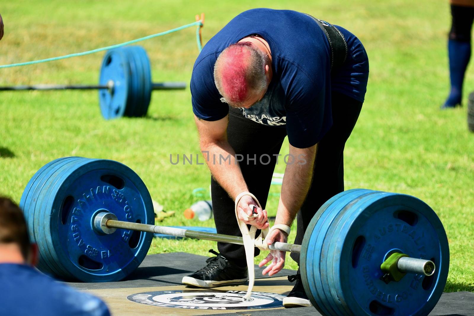Auckland, New Zealand - Mar 2020. Strongman training in a public park, log Lift and Deadlift training by Marshalkina