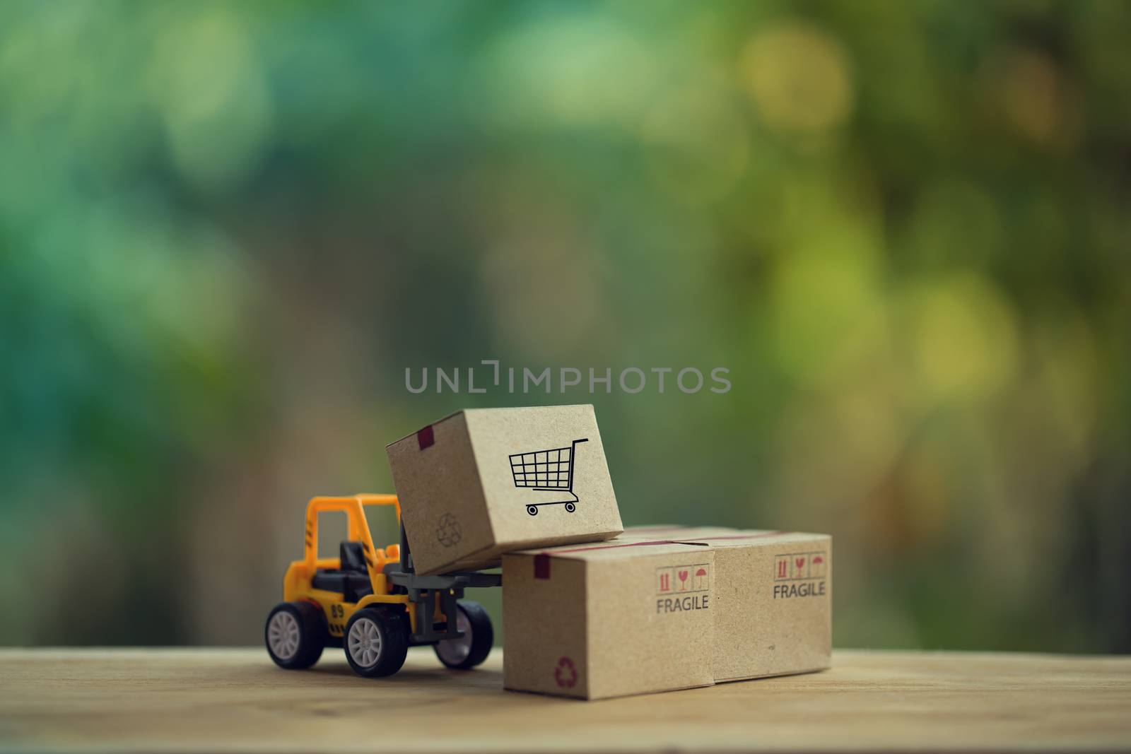 Logistic and cargo freight concept: Fork-lift truck moves a pallet with Paper boxes. depicts delivery management from the point of origin to point of consumption according to needs of customers