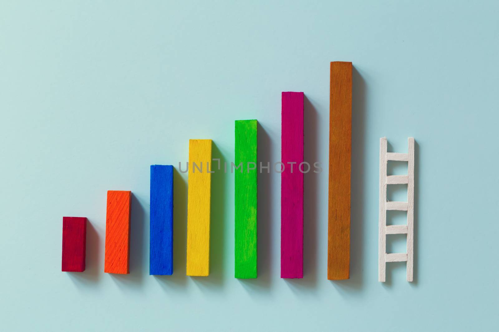 Arrange rising bar graph with stair. Concept of analysing information / Business concept growth success process : depicts the increment in annual financial budget or revenues of long term growth.