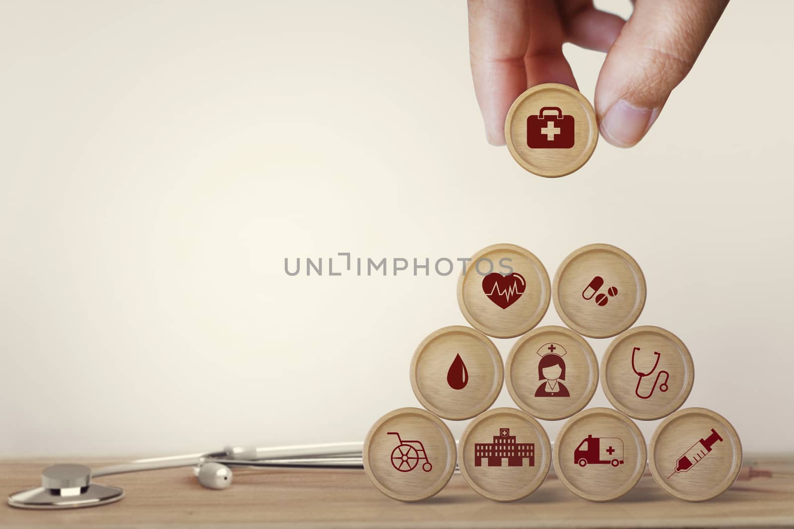 Healthcare concept about of health and medical insurance, Hand arranging block sphere stacking with icon health care medical on table wooden background.