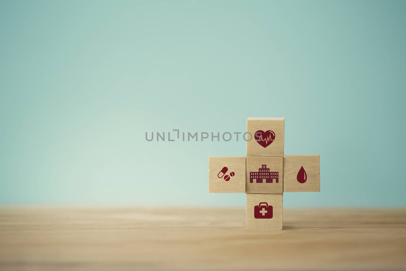 Healthcare concept about of health and medical insurance, arranging wood block stacking with icon healthcare medical on table wooden background. by setila