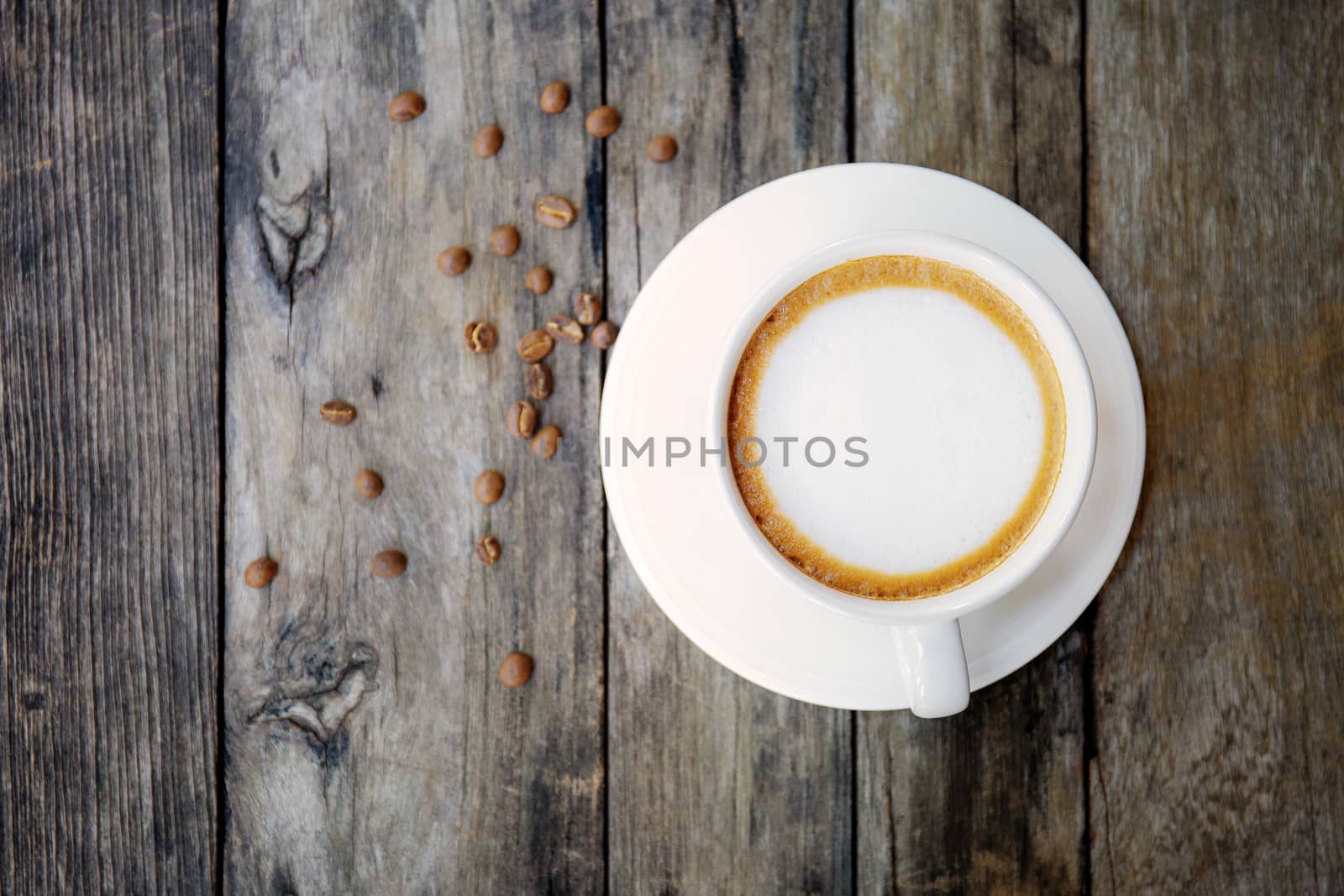 Coffee cup and seed on wood with background.