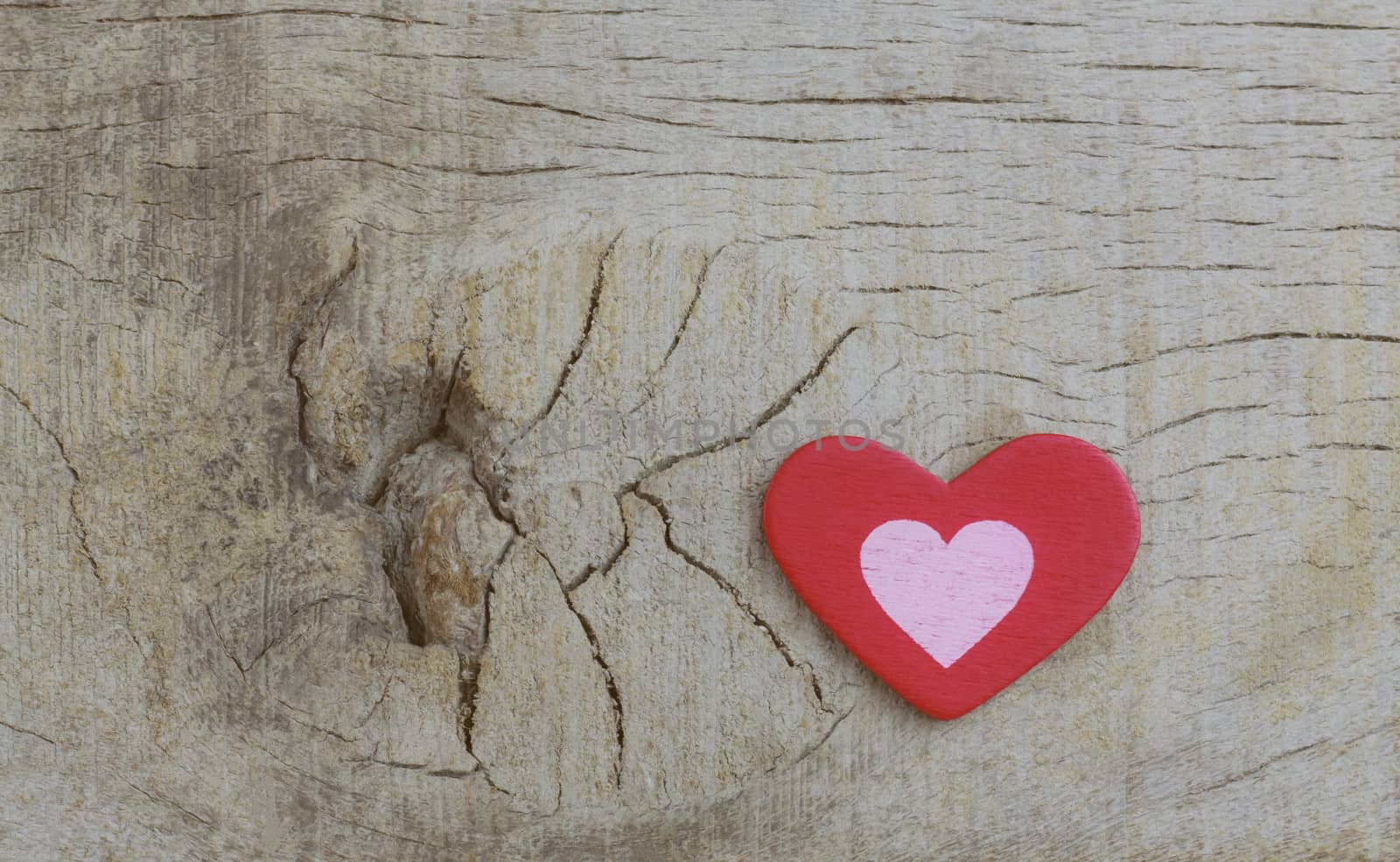 Red heart on wooden with texture background.