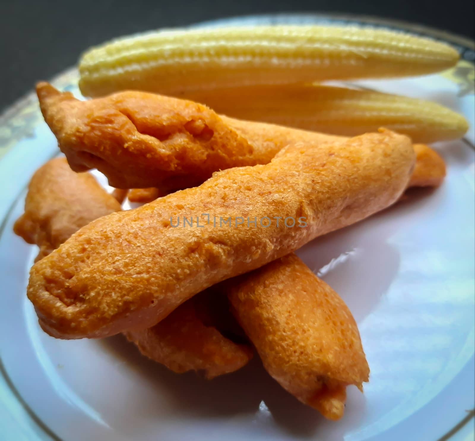 Delicious hot Baby corn baji with fresh baby corn placed in plate with white backgrounds and packed with vital antioxidants and has essential fibres