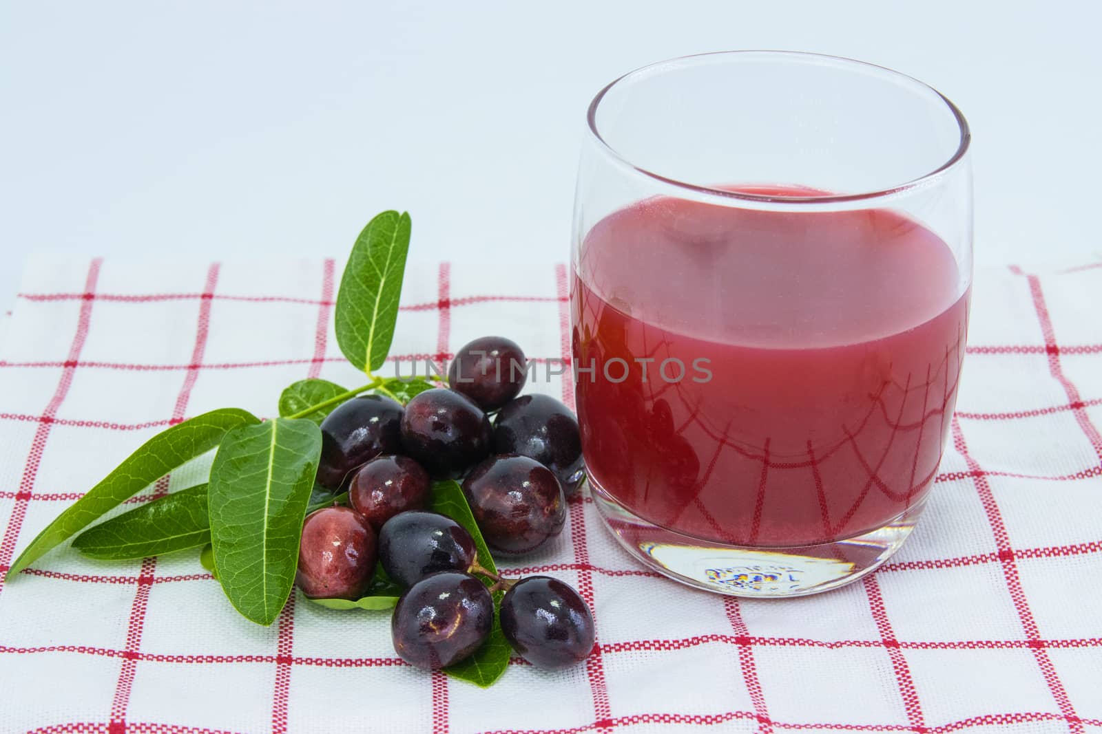 fresh Carissa carandas glass of juice with Carissa carandas fruits and Healthy drinks concept

