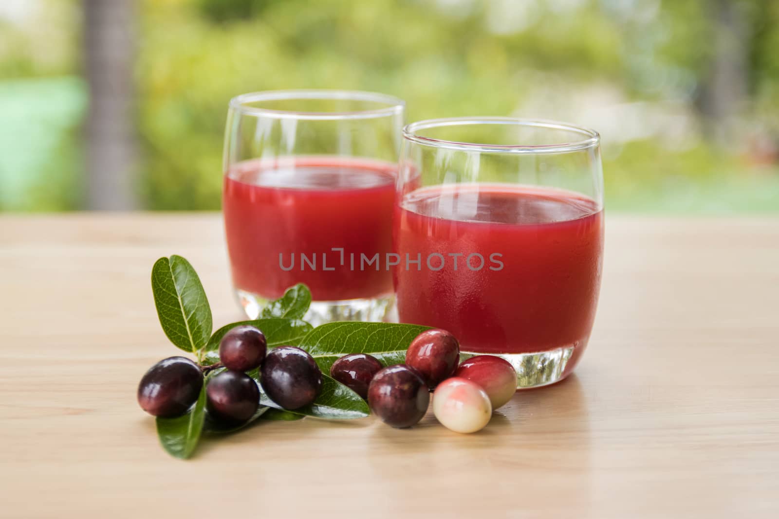 fresh Carissa carandas glass of juice with Carissa carandas fruits and Healthy drinks concept

