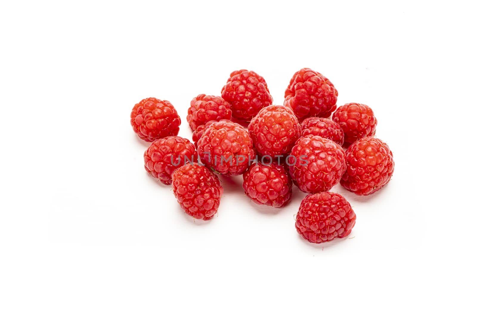 Fresh ripe raspberries isolated on white background.