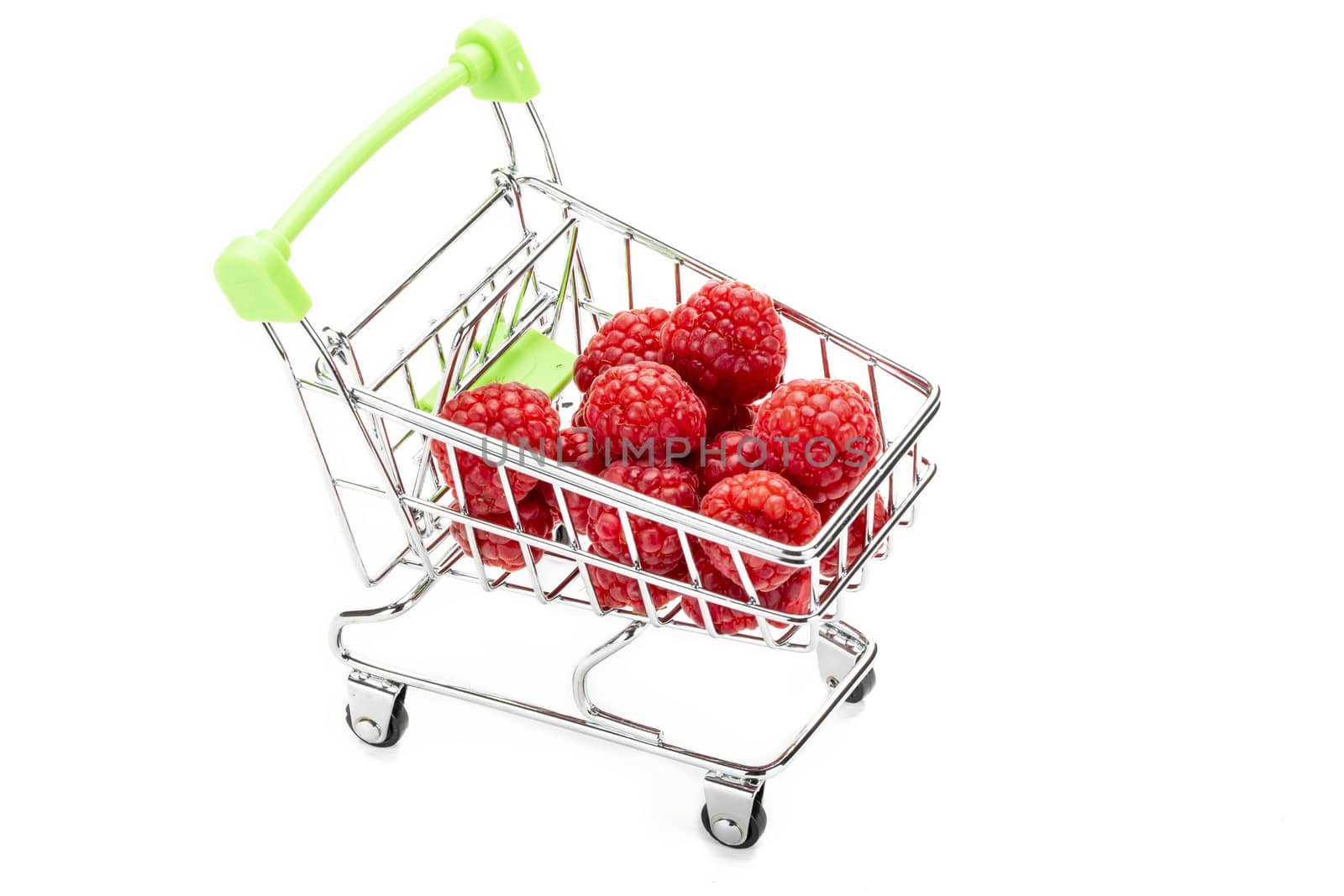 Fresh raspberries in miniature shopping cart. by Nawoot