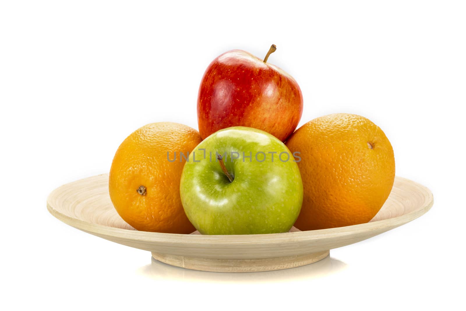 Fresh fruits on a bamboo plate, isolated on white background.