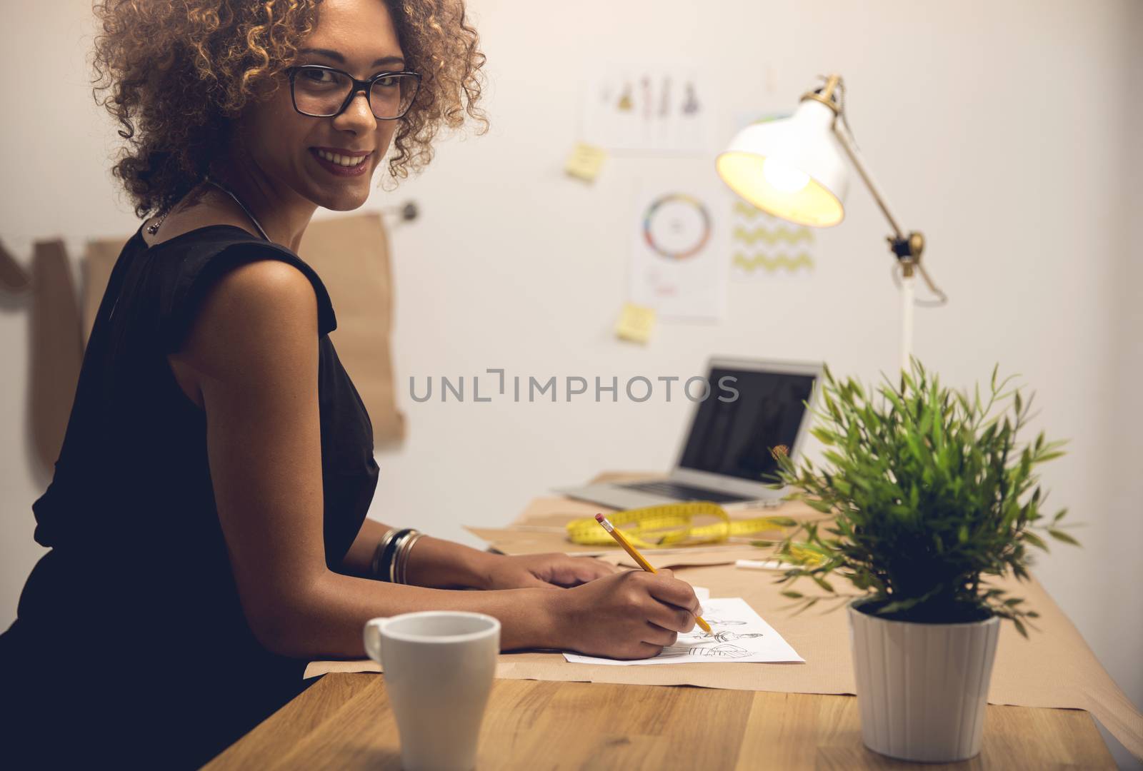 A young fashion designer working on her atelier