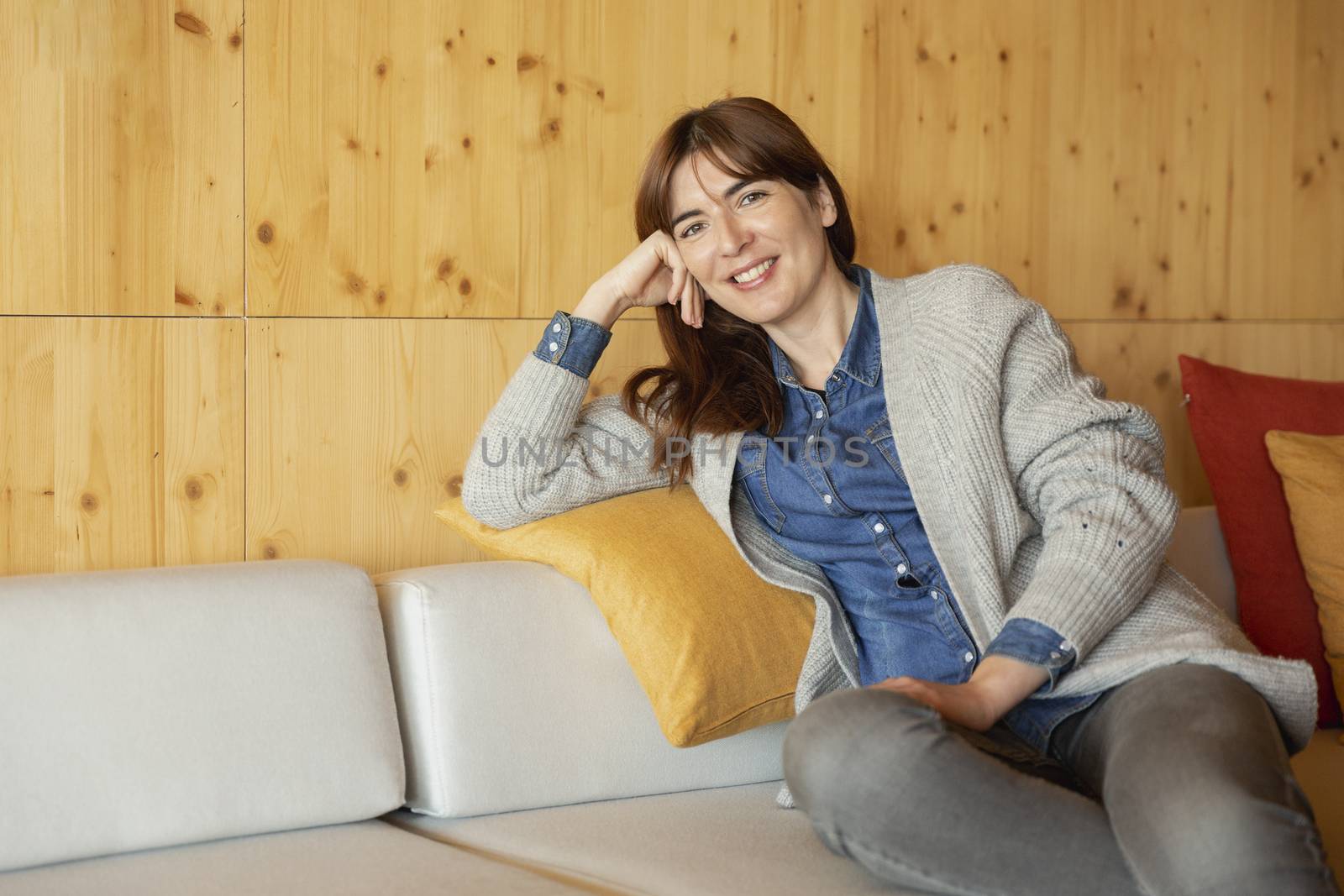 Beautiful woman sitting and relaxing on a cozy place