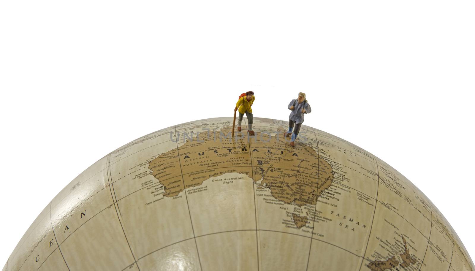 little figures backpaking australia as a big adventure with backpack and walking on a globe