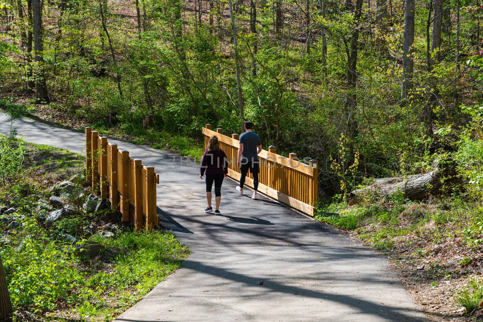 Hikers on a Bridge by jfbenning