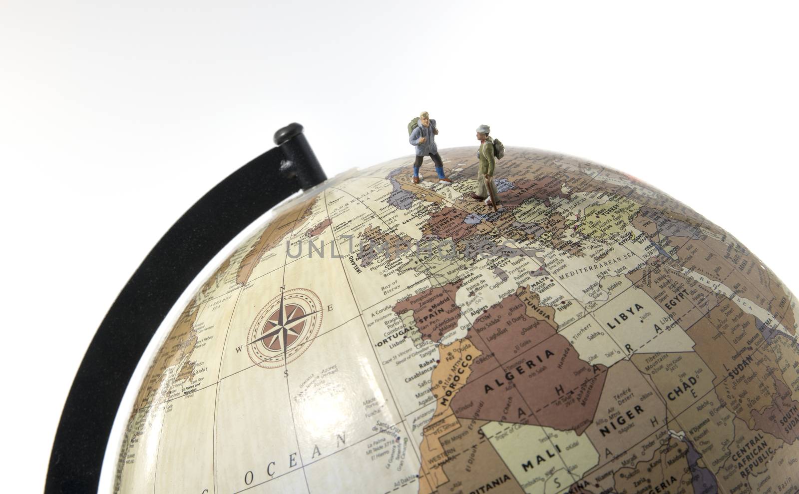 little figures backpaking europea as a big adventure with backpack and walking on a globe