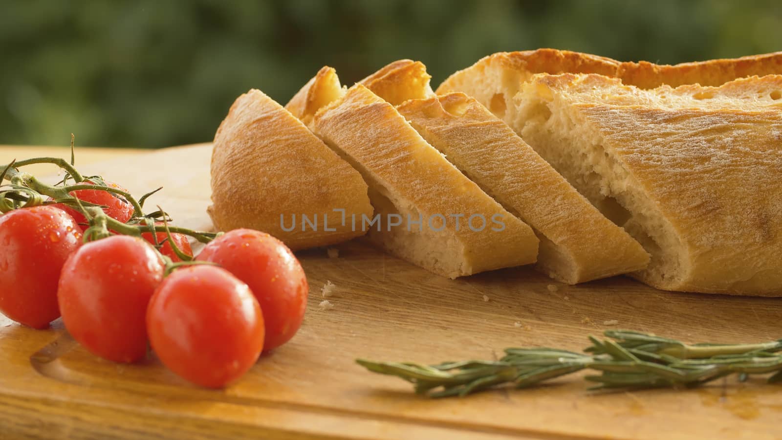 Close up tomatoes and bread on a wooden cutting board. Camera slowly moving along the board on slider. Healthy fresh food concept