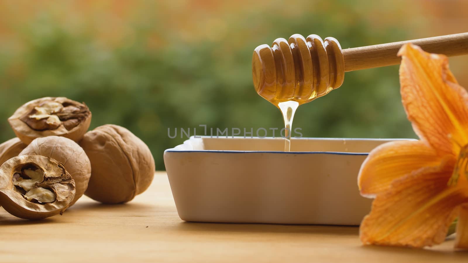 Honey pouring from honey spoon by Alize