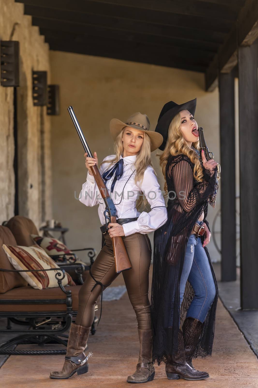 Two gorgeous blonde models dressed as cowgirls enjoying the outdoor weather